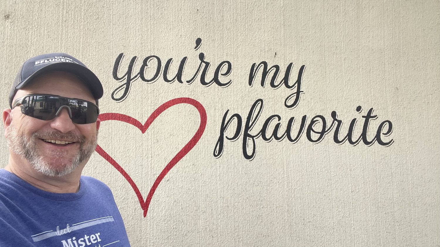 David Rogers by a 'you're my pfavorite' mural in Pflugerville